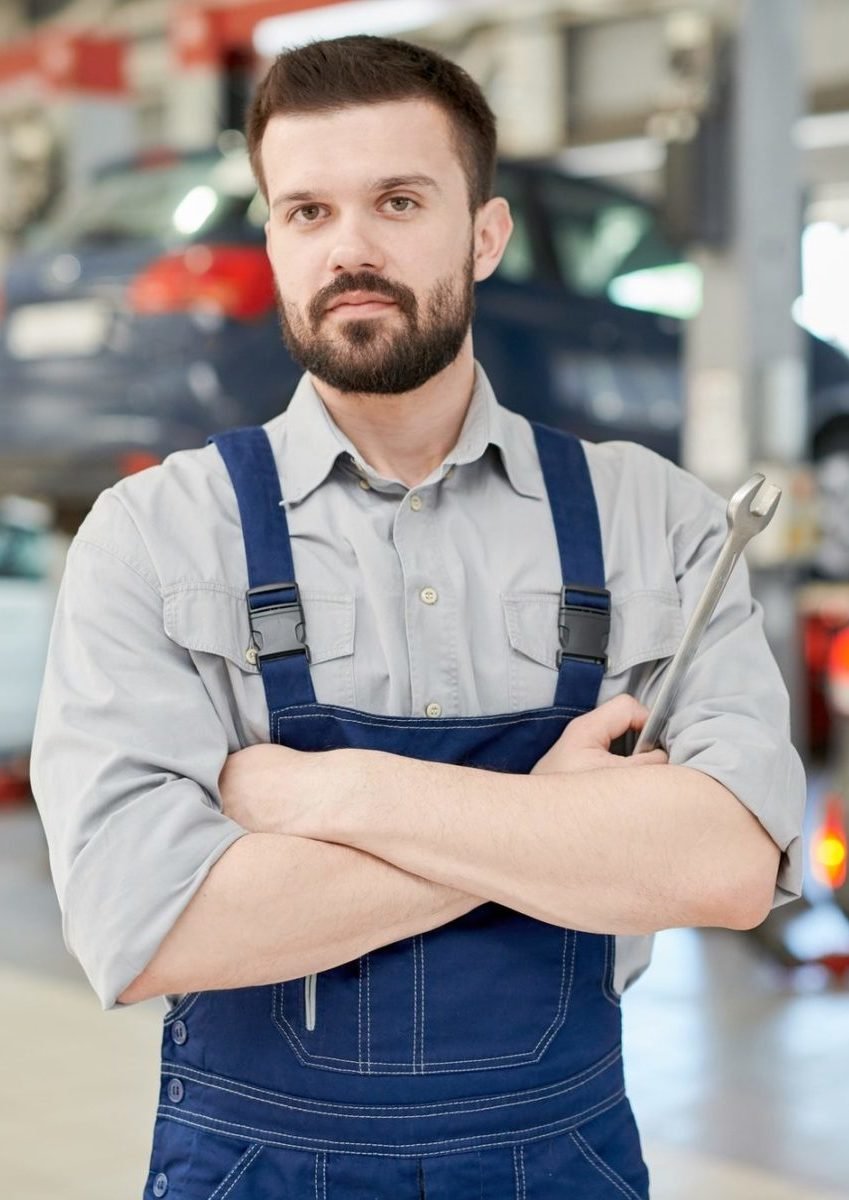Bearded Mechanic Holding Wrench E1651031348727